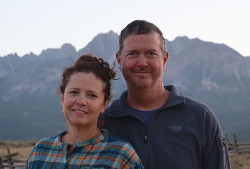 The authors of OutboundVistas with mountains in the background.